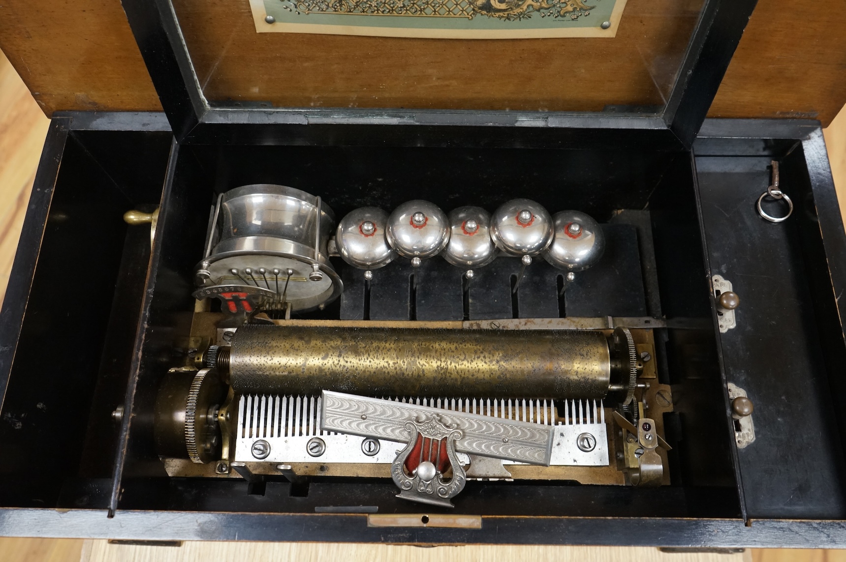 A late 19th century Swiss music box in a rosewood and ebonised case, playing twelve airs on a 52 tooth comb, five bells and a drum, 60cm wide, 27cm high, 32.5cm deep.